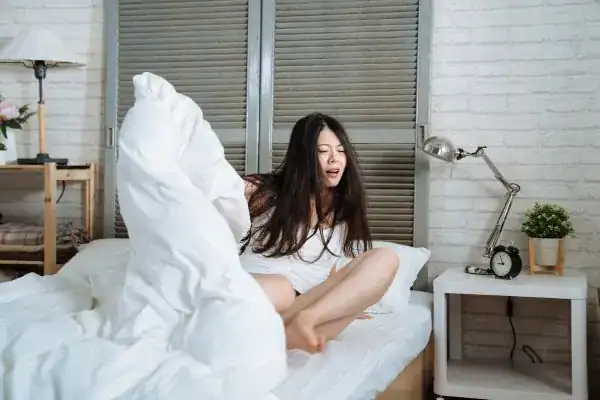 Image of woman getting up because of nighttime leaks Wigan